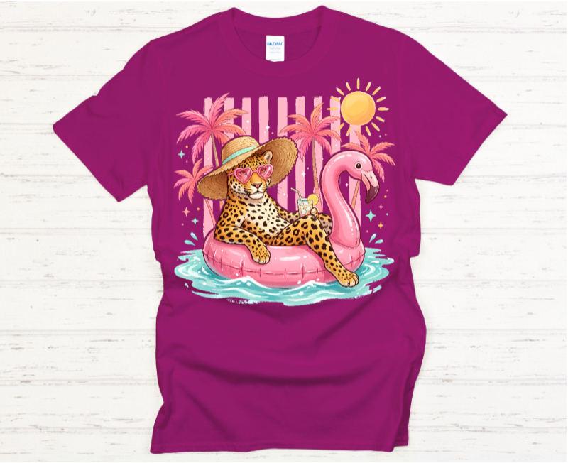 Purple t-shirt with a colorful graphic of a leopard on a flamingo pool float
