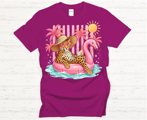 Purple t-shirt with a colorful graphic of a leopard on a flamingo pool float