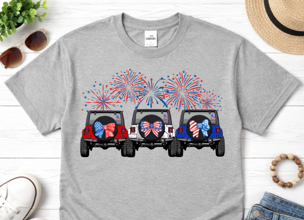 Gray t-shirt with a graphic of three jeeps with American flags and fireworks