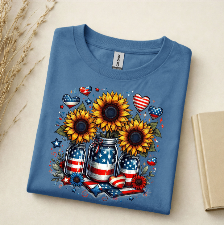 Folded blue t-shirt with sunflower design featuring American flags