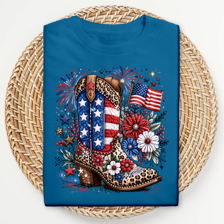 Blue t-shirt with a cowboy boot design featuring American flags and flowers