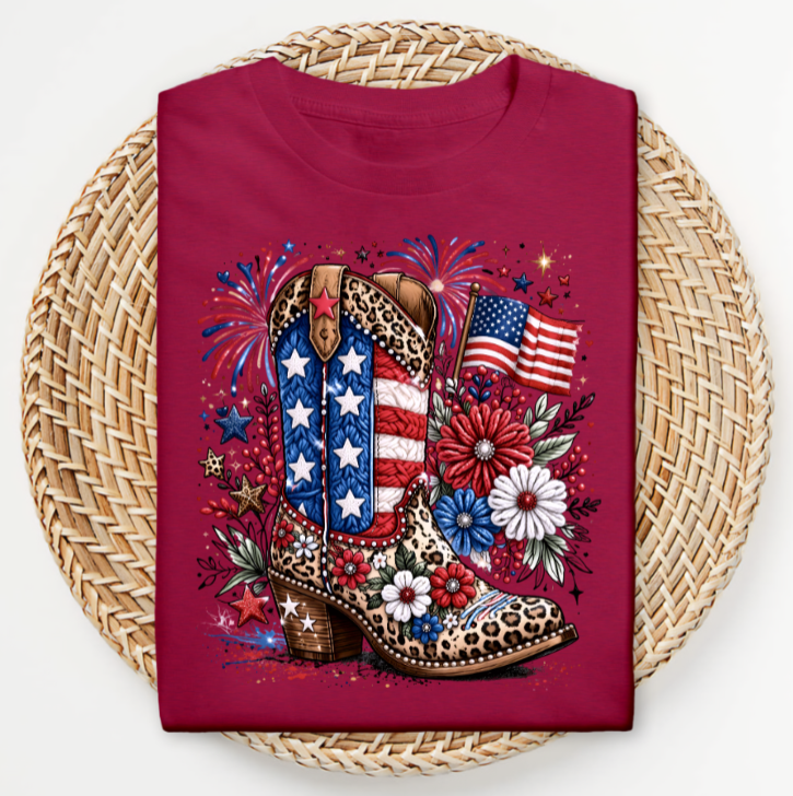 Red t-shirt with a design of a boot, American flag, and fireworks