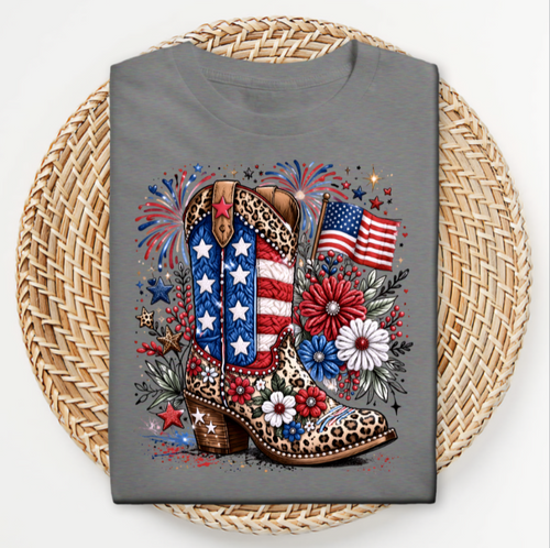 Gray t-shirt with a design of a cowboy boot, American flag, and fireworks